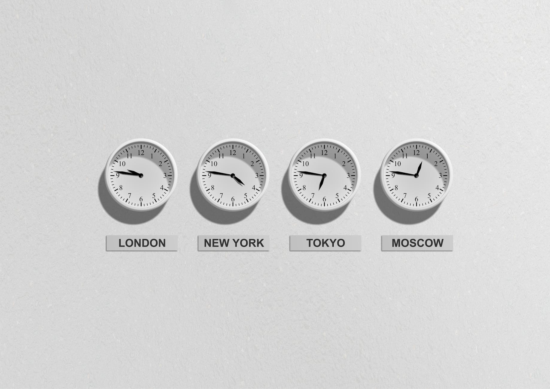 Four wall-mounted clocks labeled London, New York, Tokyo, and Moscow, displaying different times.