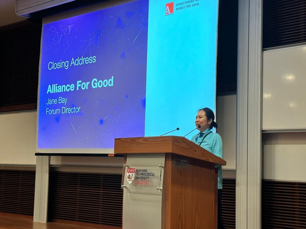 Ageisano blogger smiling among a large, diverse group of regional entrepreneurs and innovators at a major business event in Singapore.