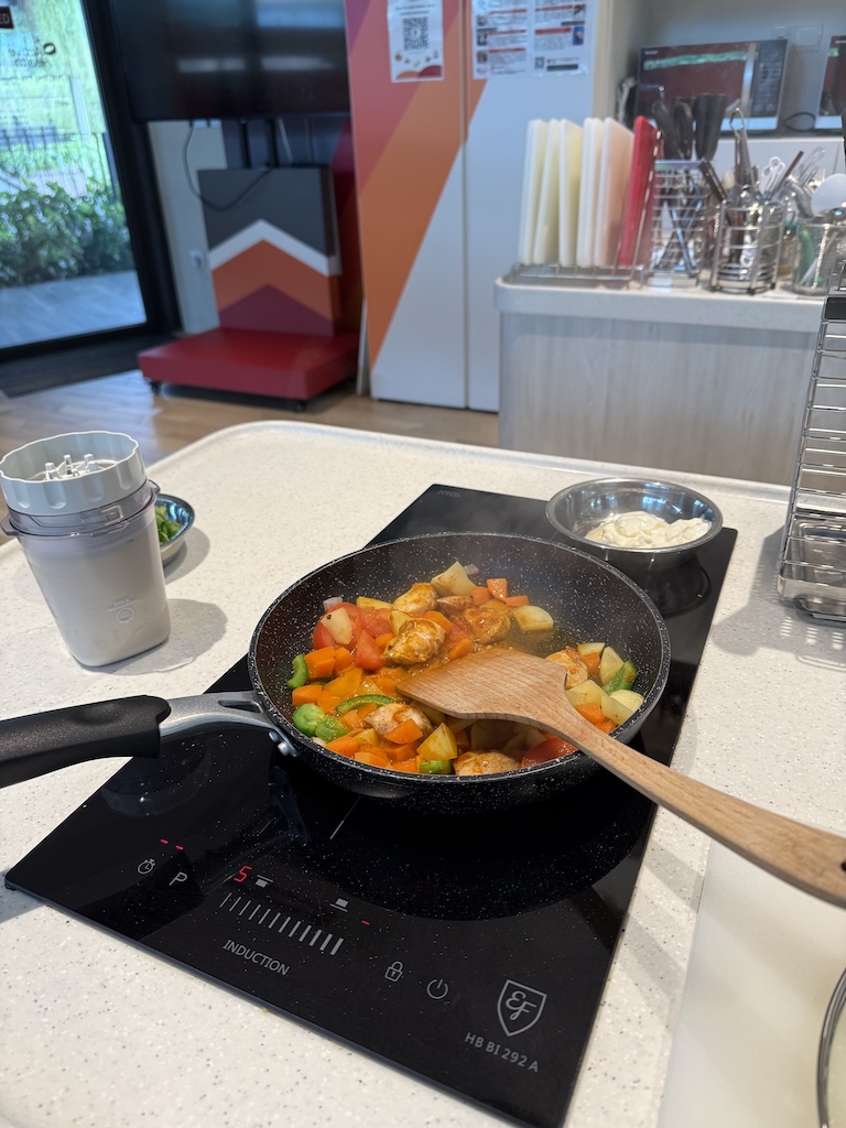 A vibrant, healthy curry chicken served in a black bowl, prepared with a high-protein blended soy milk, tofu, and yogurt base for optimal calcium and muscle health.
